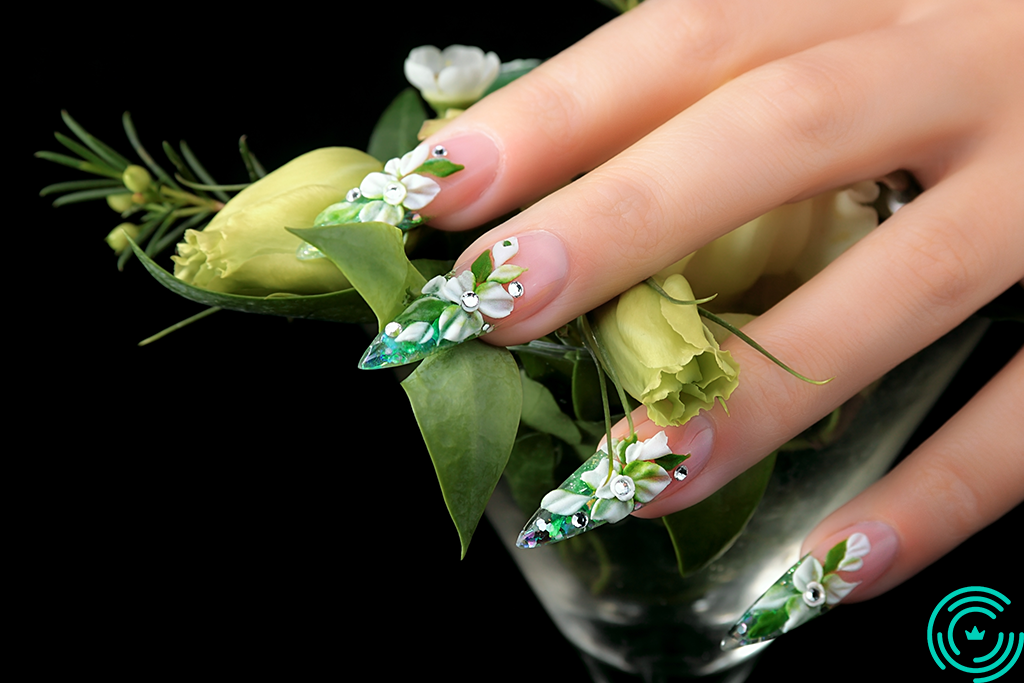 3D manichiure Woman's hand with long, sharp nails, with 3D floral pattern, predominantly green